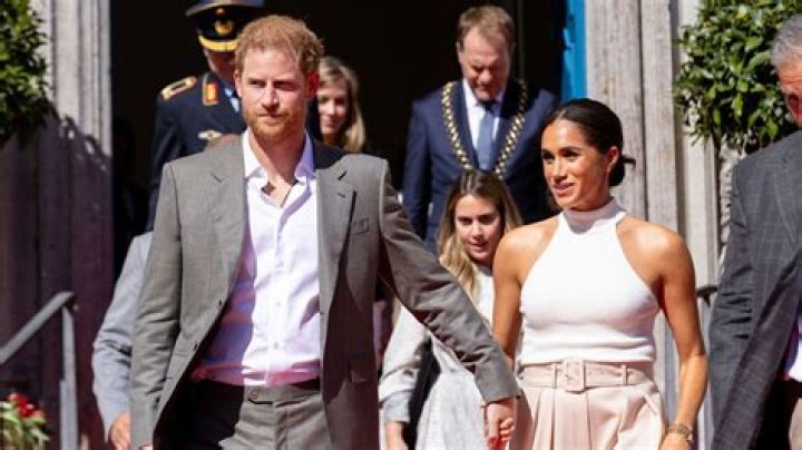 Meghan Markle is talking into a microphone.